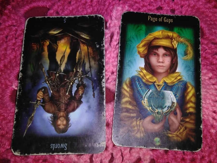 five of swords reversed page of cups tarot cards